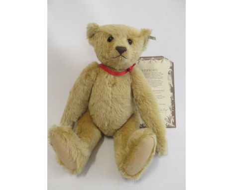 A large Steiff 1907 replica teddy bear, with felt pads, button eyes, ear button and label, with certificate, 55cm long (Est. 