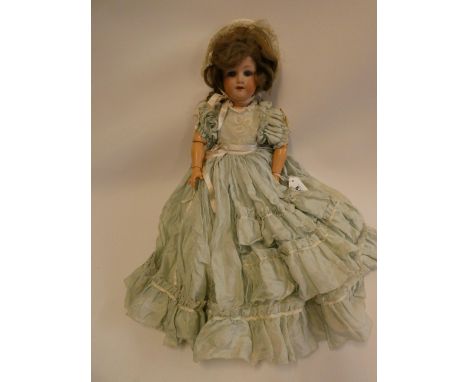 An Armand Marseille bisque socket head doll, with blue glass sleeping eyes, open mouth, teeth, light brown wig, wood and comp