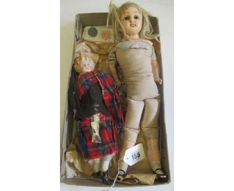 Two antique dolls comprising a 10" Scottish bisque head boy, with moulded hair, bisque lower limbs and fabric body, and a 14 
