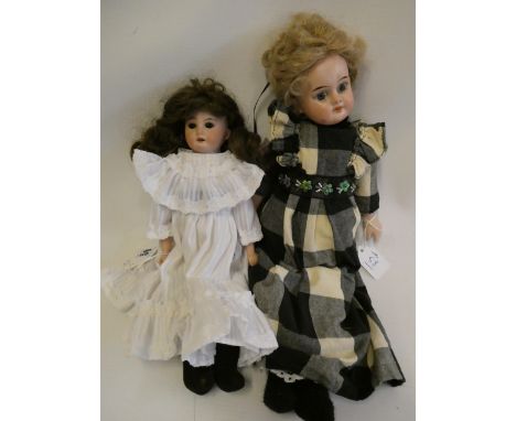 Two Armand Marseille bisque shoulder head dolls, comprising one 3200 with brown glass fixed eyes, open mouth, curly brown wig