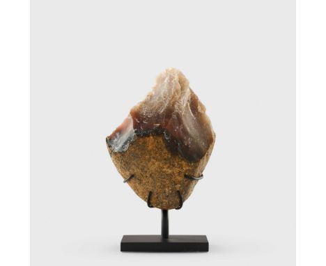  ACHEULEAN STONE CHOPPER MOROCCO, LOWER PALEOLITHIC, C. ONE MILLION YEARS B.P. knapped stone, protobiface form, raised on a b