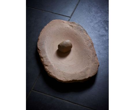  AFRICAN NEOLITHIC GRINDING STONE AND PESTLE CENTRAL SAHARA, C. 4TH – 3RD MILLENNIUM B.C. carved sandstone, with a central de
