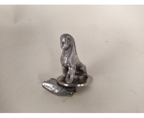 A vintage style Sphynx car mascot plus a 'pig in blanket' and a Brooklands car badge