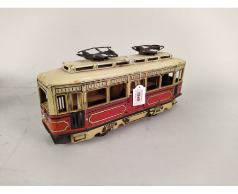 A tin plate vintage clockwork tram, marked 'SG' on doors, 15" long (playworn condition)