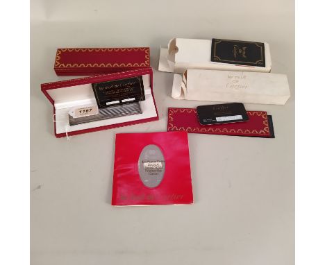 A boxed Cartier white metal 'Le Must' table lighter, just under 5" long (light wear to metal) comes with box, Cartier guarant