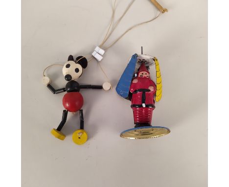 A tin plate Father Christmas whirling figure plus a selection of marbles and a small Mickey Mouse string puppet