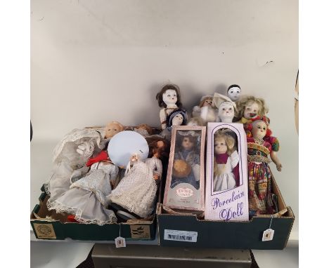 A large selection of vintage porcelain head dolls, some boxed, some with moving eyes and a couple are musical plus a small gr