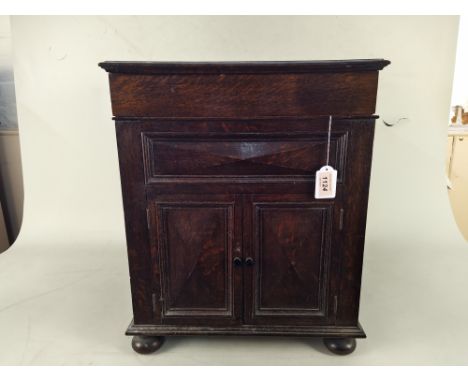A vintage wood lidded gramophone music cabinet with two small doors