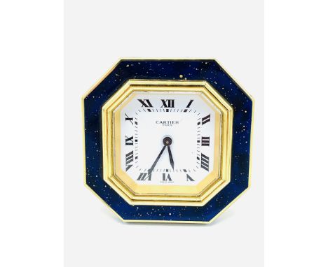 Cartier travel alarm clock with octagonal blue enamel and gilt face and Roman numerals, 7.5cm x 7.5cm, going. Estimate £120-1