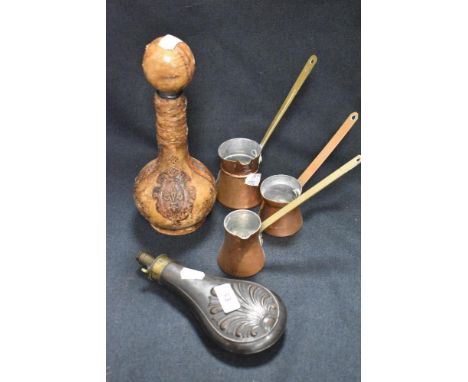 A set of three copper measures with a decanter and copper bodied shot flask.