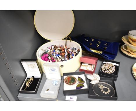 A selection of modern costume jewellery including yellow metal necklaces, enamel brooches and earrings