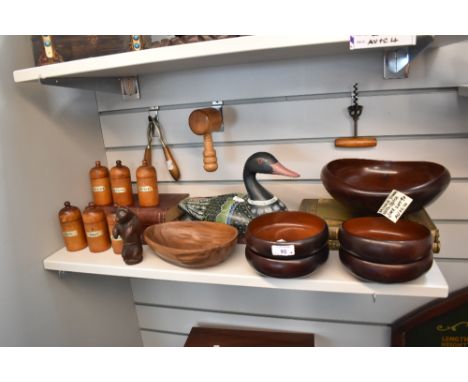 A selection of treen wood kitchen wares including spice jars, bowls, corkscrew and a bear form nut cracker.