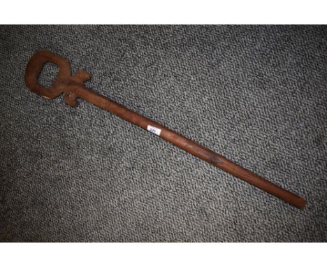 A 20th century African walking stick of plain design with hoop handle.