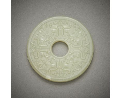 Chinese carved jade bi decorated in low relief on both sides with geometric forms. Carved of a pale yellow-green stone.Diamet