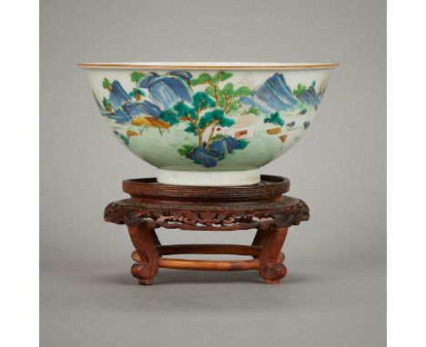 Chinese famille verte porcelain bowl decorated with a painted landscape, late 19th century. With a cafe au lait border and an