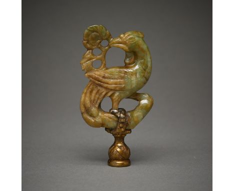 Carved jade finial in the form of a phoenix holding a flower. With a metallic element to attach it to a base. Carved from a d