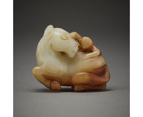 Chinese Qing Dynasty carved pale jade in the form of a monkey climbing a horse. With russet inclusions.Height: 1 1/2 in x wid