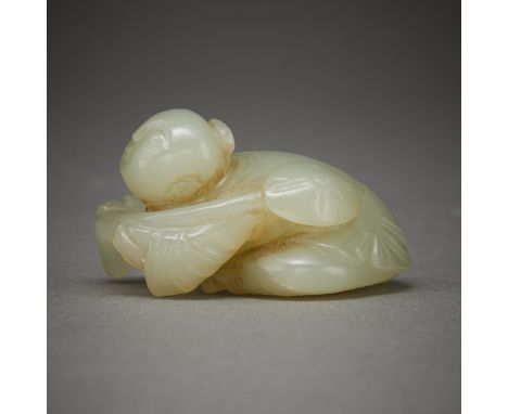 Chinese PRC carved jade figure of a boy holding a lotus pod. Carved of a light green, semi-translucent celadon jade.Height: 1