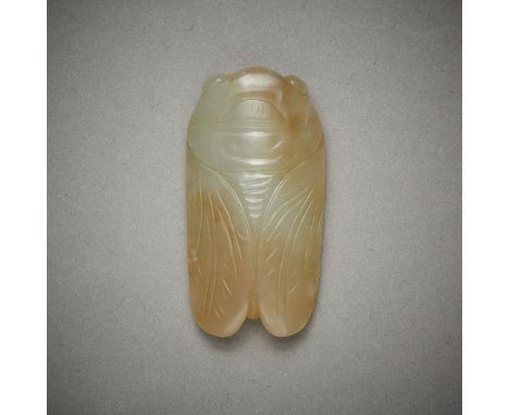 Chinese carved jade in the form of a cicada. Carved of a bluish-green jade with russet inclusions.Height: 1/4 in x width: 1 i