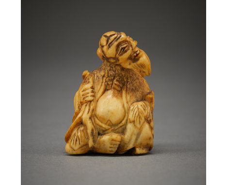 Chinese carved antler netsuke in the form of a seated elderly man.Height: 1 3/4 in x width: 1 1/4 in x depth: 1 in. Weight: 1