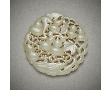 Chinese carved and pierced jade disc depicting gourds among thick foliage. Carved of a pale green-white jade.Diameter: 2 1/4 