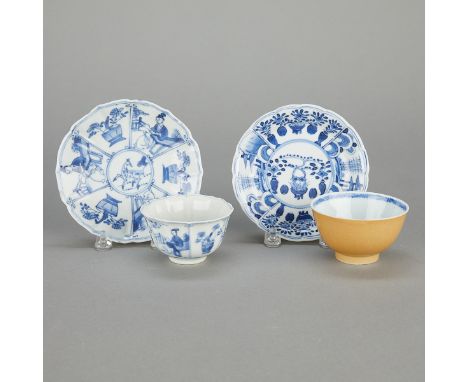 Group of Kangxi Chinese porcelain cups and saucers, two cups and two saucers. One pair with blue and white interiors and yell