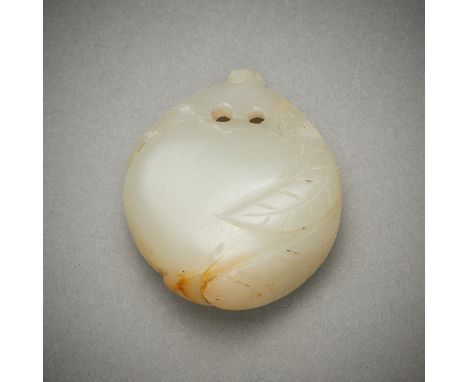 Chinese jade toggle carving in the form of a peach. Carved of a pale green-white jade with russet inclusions.Height: 3/4 in x