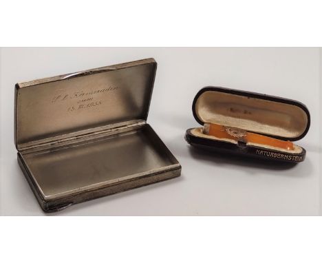 A 900 silver case with engine turn decoration and an amber cigarette holder in case. 