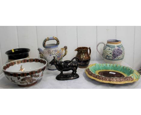 A Poole Jug 18cm, A Copper Lustre Jug 14cm, Minton Majolica dish 33cm wide, Black Cow-Creamer 18cm long, Bowl and Jardiniere 