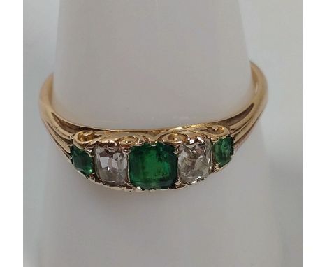 An emerald and diamond 3 stone ring set in 18ct gold. Size R. 