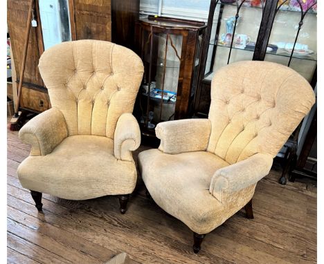 A pair of button back upholstered armchairs.  early 20th century. 