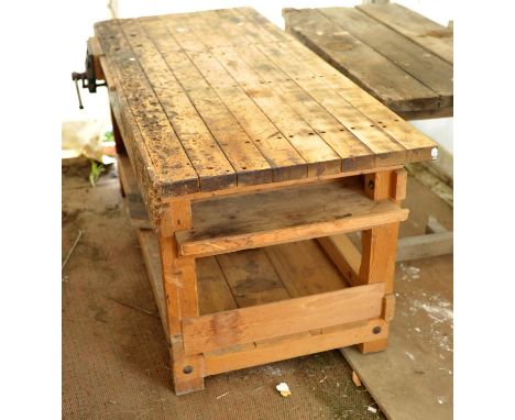 A pine work bench, with drawer cavities and shelf under tier, fitted with a heavy duty Record vice, the table 85.5cm high x 1