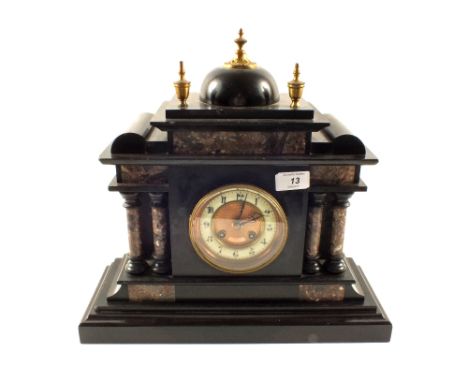 A black and rouge marble striking mantel clock