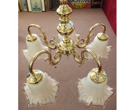 A five branch Brass electrolier and four green lamp shades