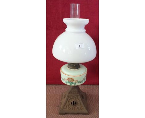 An Iron base opal glass oil lamp