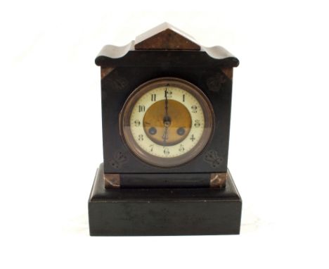 A black slate striking mantel clock