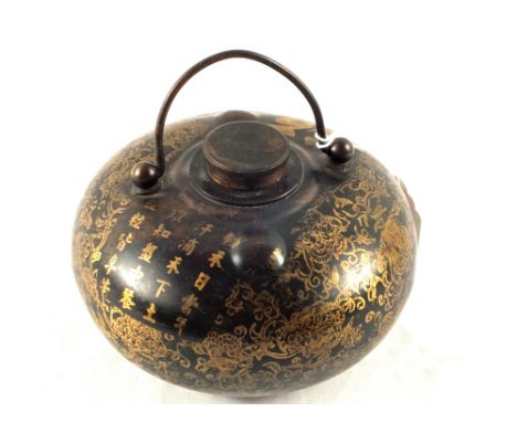 A Chinese black and gilt canister with calligraphy