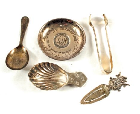 A 1900 shilling inset in commemorative Silver dish, two caddy spoons, tongs and a paperclip