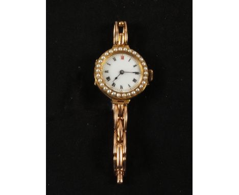 A 9ct Gold lady's watch with enamel dial surrounded by Pearls