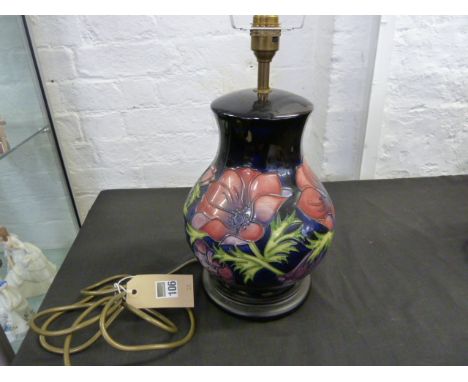 Moorcroft flower decorated table lamp with blue background, height 27cm