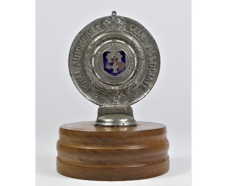 A RAC associate, Cheshire Automobile Club car badge number F70864, mounted on a wooden base. 
