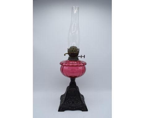 Victorian cranberry oil lamp with a later chimney. Untested condition. Some damage to metalwork. See photos. 59cm tall with c