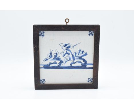 19th century framed blue and white Delft tile. There is some crazing and also some surface damage. 16cm tall including wall f
