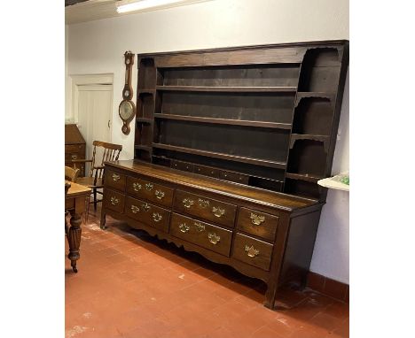 Georgian large oak dresser with spice drawers: 4 draws wide. All original brass handles. Some damage to the wood around the s