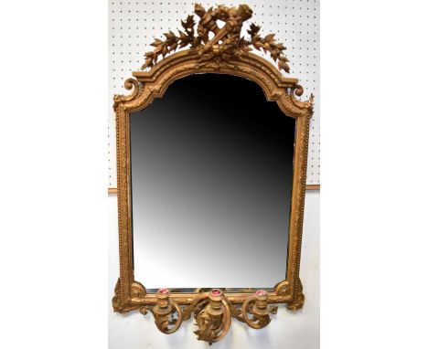 A 19th century gilt-framed girandole mirror of arched form surmounted by a wreath and crossed torches and leaves, the bottom 