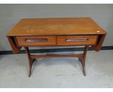 A mid 20th century teak G Plan flap sided sofa table fitted two drawers 