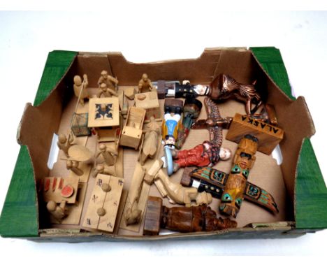 A box containing wooden tourist figures, a novelty lighter in the form of a mermaid  
