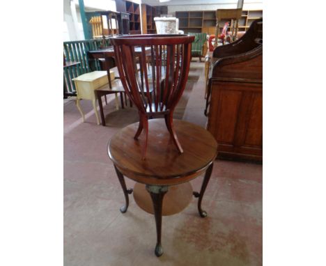 A 20th century continental circular mahogany two tier occasional table together with a stained beech planter  