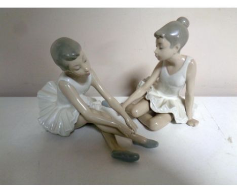 Two Nao figures, seated ballerinas 
