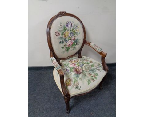 A carved beech salon armchair upholstered in a tapestry fabric (as found)  